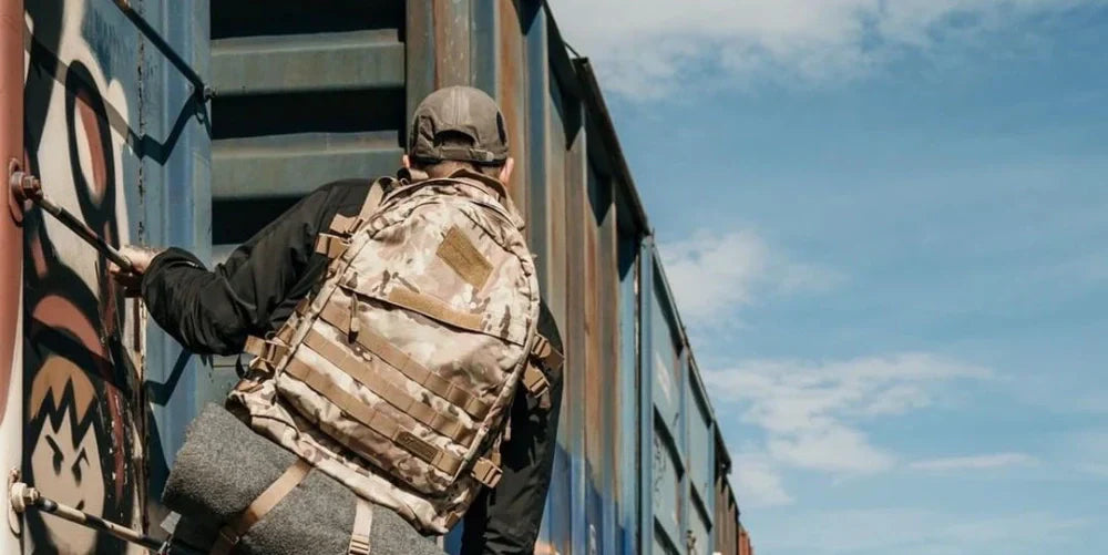 Traveler with a Highland Tactical Backpack on a train looking towards adventure.