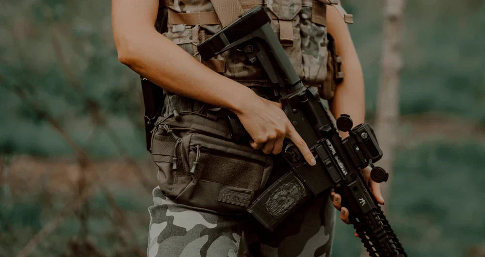 Woman in the forest with a tactical waist bag and hands free sling bag